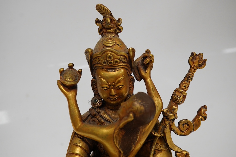 A Tibetan gilt bronze figure of a deity and consort, 15cm high. Condition - good